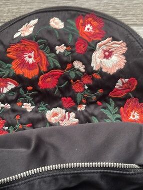 Black backpack with embroidery and flaw